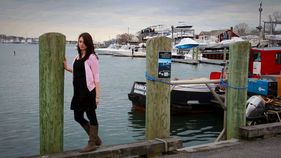 A Cinemagraph gif taken at the Falmouth Harbor on Cape Cod, Massachusetts. The Image shows a woman in front of the water. This is made using a dissolve loop.